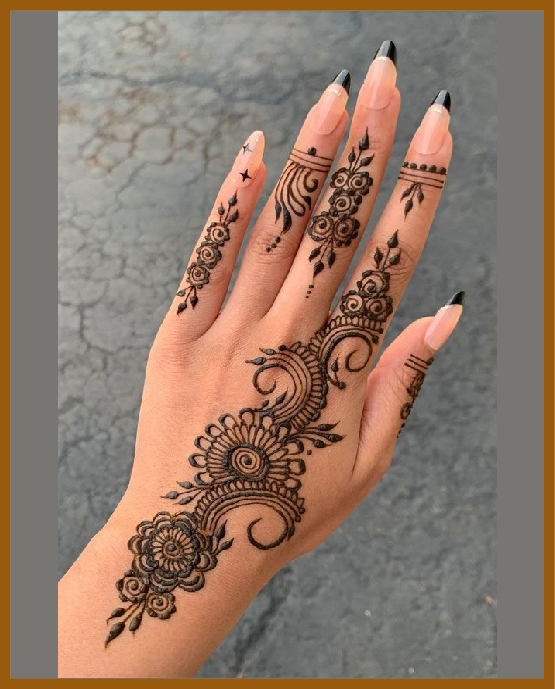 Aesthetic Mehndi Design For Back Hand With Curled Vines And Floral Touches